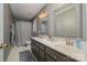 Bathroom with double sinks, framed mirrors, modern vanity and tiled floors at 159 Pitts School Nw Rd, Concord, NC 28027