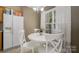 A quaint dining room featuring a white table and chairs with natural light from a large window at 159 Pitts School Nw Rd, Concord, NC 28027