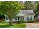 Inviting single-story home with mature landscaping and blue shutters at 159 Pitts School Nw Rd, Concord, NC 28027