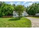 Exterior view of house with mature landscaping and trees at 159 Pitts School Nw Rd, Concord, NC 28027