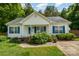 Charming single-story home with light siding, blue shutters, and a well-manicured front yard with mature landscaping at 159 Pitts School Nw Rd, Concord, NC 28027