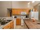 Functional kitchen featuring wood cabinets, modern appliances, an island with seating, and lots of counter space at 159 Pitts School Nw Rd, Concord, NC 28027