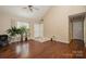 Spacious living room with hardwood floors, a vaulted ceiling, access to the front door, and plenty of natural light at 159 Pitts School Nw Rd, Concord, NC 28027