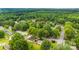 An aerial shot shows the neighborhood with mature trees and lush green lawns at 1606 Northwoods Dr, Kings Mountain, NC 28086