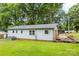 Home's light blue siding is complemented by its expansive backyard lawn at 1606 Northwoods Dr, Kings Mountain, NC 28086