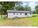 Rear view of the home, showing the light blue siding and grassy backyard at 1606 Northwoods Dr, Kings Mountain, NC 28086