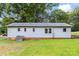 An expansive backyard lawn surrounds the light blue home at 1606 Northwoods Dr, Kings Mountain, NC 28086