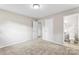 A spacious bedroom with neutral carpet, a ceiling light, and doors to closets and bathroom at 1606 Northwoods Dr, Kings Mountain, NC 28086