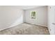 Cozy bedroom with neutral walls and carpet, featuring a window for natural light at 1606 Northwoods Dr, Kings Mountain, NC 28086