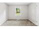 Neutral bedroom features a carpeted floor and a window for ample natural light at 1606 Northwoods Dr, Kings Mountain, NC 28086