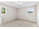 Neutral bedroom features a carpeted floor and two windows for ample natural light at 1606 Northwoods Dr, Kings Mountain, NC 28086