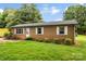 Classic brick ranch-style home with well-maintained lawn and mature trees at 1606 Northwoods Dr, Kings Mountain, NC 28086