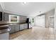 Eat-in kitchen features gray cabinets, stainless steel appliances, and neutral tile flooring at 1606 Northwoods Dr, Kings Mountain, NC 28086