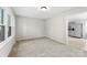 Bright, neutral living room featuring plush carpeting and ample natural light from a large window at 1606 Northwoods Dr, Kings Mountain, NC 28086