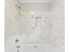 A bathtub with a white marble tile surround and recessed niche at 1606 Northwoods Dr, Kings Mountain, NC 28086