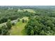 Scenic aerial view of a home with verdant trees and sprawling green space at 1691 Hill River Rd, Hiddenite, NC 28636