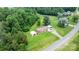 Property featuring a cozy home, ample green space, and a convenient outbuilding for storage at 1691 Hill River Rd, Hiddenite, NC 28636