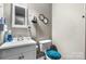 This bathroom has a gray wall, white toilet, and a blue toilet seat cover at 1691 Hill River Rd, Hiddenite, NC 28636