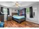 Cozy bedroom with hardwood floors, a comfortable bed, and natural lighting at 1691 Hill River Rd, Hiddenite, NC 28636