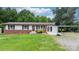 Ranch-style home with a brick facade, well-kept lawn, and convenient covered parking at 1691 Hill River Rd, Hiddenite, NC 28636