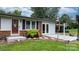 Charming home featuring brick accents, a well-manicured lawn, and a covered parking area at 1691 Hill River Rd, Hiddenite, NC 28636