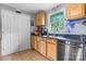 Well-organized kitchen featuring wooden cabinets, updated sink and ample countertop area at 1691 Hill River Rd, Hiddenite, NC 28636
