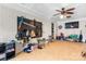 Spacious recreational room with ceiling fan, TV, peg board, and hardwood floors at 1691 Hill River Rd, Hiddenite, NC 28636