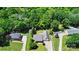 Aerial view of property with lush tree coverage and a well-manicured lawn and garden at 185 Eastcliff Se Dr, Concord, NC 28025