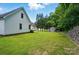 Expansive backyard featuring a well-maintained lawn, storage shed, and lush bamboo for added privacy at 185 Eastcliff Se Dr, Concord, NC 28025