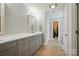 Bathroom with vanity and tile floor that leads to closet with shelving at 185 Eastcliff Se Dr, Concord, NC 28025