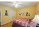Bedroom with a white closet door, ceiling fan, and multiple wall decor pieces at 185 Eastcliff Se Dr, Concord, NC 28025