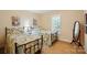 Cozy bedroom featuring two twin beds with floral bedding, shuttered windows, and neutral carpeting at 185 Eastcliff Se Dr, Concord, NC 28025