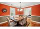 Traditional dining room featuring hardwood floors, a wooden table with seating for six, and an elegant chandelier at 185 Eastcliff Se Dr, Concord, NC 28025