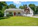 Charming home with a well-manicured lawn and a welcoming red front door at 185 Eastcliff Se Dr, Concord, NC 28025