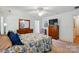 Bright main bedroom with a wooden dresser, a ceiling fan, and patterned bedding at 185 Eastcliff Se Dr, Concord, NC 28025