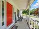 Cozy front porch featuring a vibrant red door and classic rocking chairs at 185 Eastcliff Se Dr, Concord, NC 28025