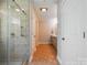 Hallway view with glass door leading to stand up shower with tile surround at 185 Eastcliff Se Dr, Concord, NC 28025