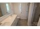Bathroom featuring double sinks, large vanity, tile floors, and a glass-enclosed shower at 1922 Highland Park Dr, Charlotte, NC 28269