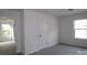 Bedroom features neutral carpet, white walls, and ample natural light from the large window at 1922 Highland Park Dr, Charlotte, NC 28269