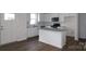 Bright kitchen with white cabinets, granite countertops, stainless steel appliances, and an island at 1922 Highland Park Dr, Charlotte, NC 28269