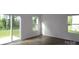Open living room with wood floors, sliding glass doors to the yard, and bright natural light at 1922 Highland Park Dr, Charlotte, NC 28269