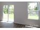 Bright living room with wood floors, a sliding glass door to the yard, and a large window at 1922 Highland Park Dr, Charlotte, NC 28269