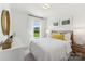 Bright bedroom with white bedding, complemented by natural light and minimalist decor for a calming ambiance at 1944 Westerhill Dr, Fort Mill, SC 29708