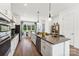 Well-lit kitchen features stainless appliances, island, white cabinets, and an open floorplan at 1944 Westerhill Dr, Fort Mill, SC 29708