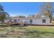A house backyard featuring a green lawn, wooden decks, blue skies, and an AC unit at 2315 Circle Dr, Great Falls, SC 29055