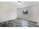 Minimalist bedroom with a large window, modern flooring, and neutral colors at 2315 Circle Dr, Great Falls, SC 29055