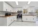Well-lit kitchen featuring white cabinets, stainless steel appliances, and a stylish backsplash at 2315 Circle Dr, Great Falls, SC 29055