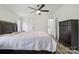 A main bedroom with a ceiling fan, a queen sized bed, a dresser, and views to the ensuite bathroom at 2315 Circle Dr, Great Falls, SC 29055