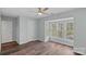 Sunlit bedroom with hardwood floors, ceiling fan, neutral walls, and a large bay window with a serene view at 3308 Selwyn Farms Ln # 5, Charlotte, NC 28209