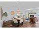 Open-concept dining area flows into the living room, featuring a fireplace and hardwood floors at 3308 Selwyn Farms Ln # 5, Charlotte, NC 28209